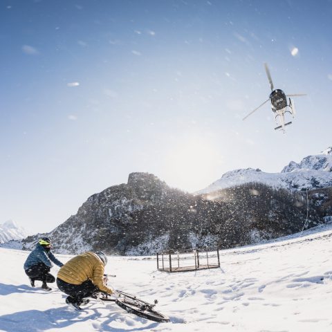 Helicopter dropping off Snow Bikers