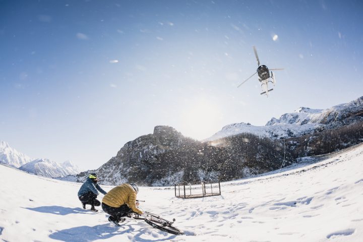 Helicopter dropping off Snow Bikers