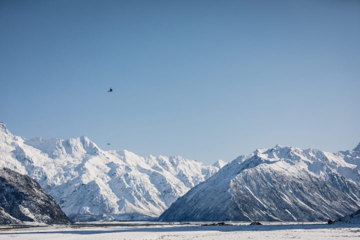 Helicopter above NZ Mountains and Valley in Winter