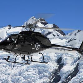 Black helicopter flying over Mt Cook