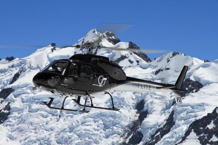 Black helicopter flying over Mt Cook