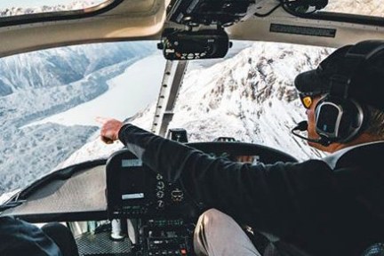 Helicopter with the pilot flying over Mt Cook