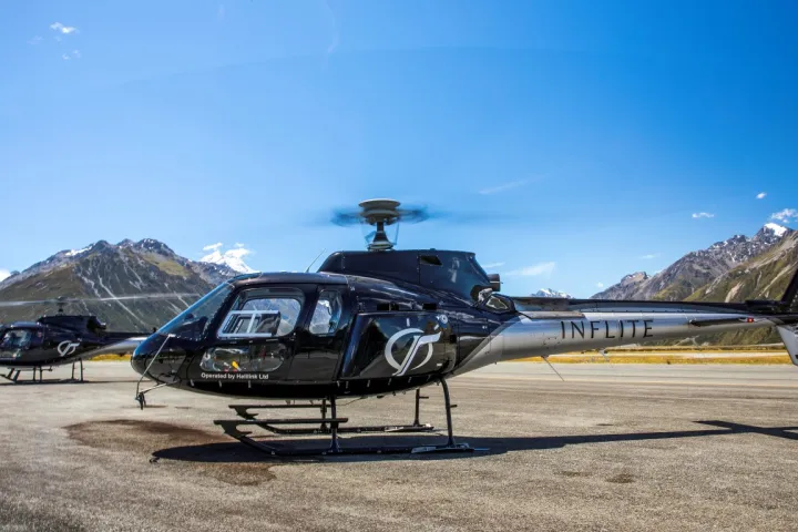 black helicopter preparing to fly over mt cook