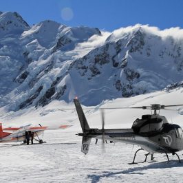 Ski plane and helicopter lands on mt cook