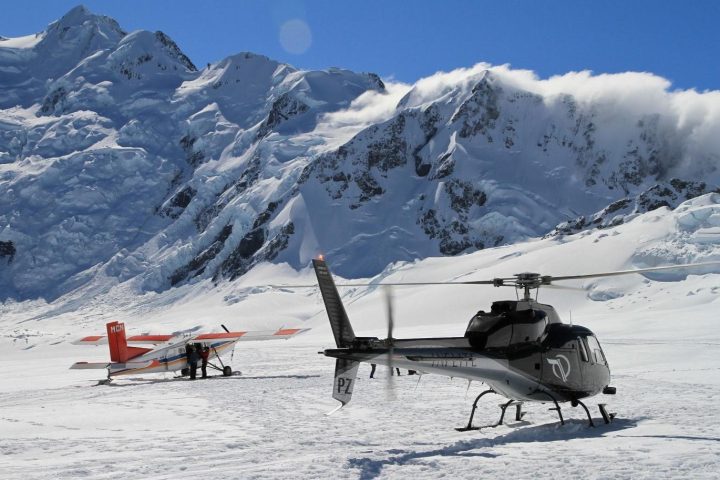 Ski plane and helicopter lands on mt cook
