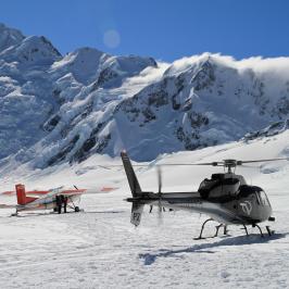 Ski plane and helicopter lands on mt cook