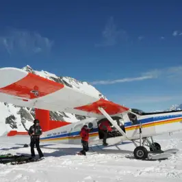 4 people getting on board on ski planes