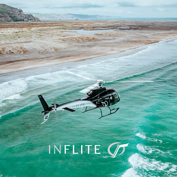 Inflite helicopter flying over the beach
