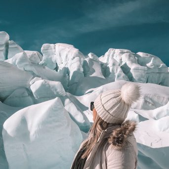 a person standing on a snow covered mountain