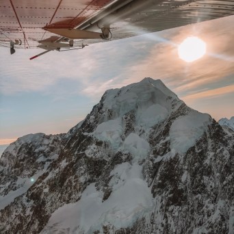 a man standing on top of a snow covered mountain
