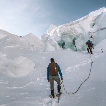 a man standing on top of a snow covered mountain