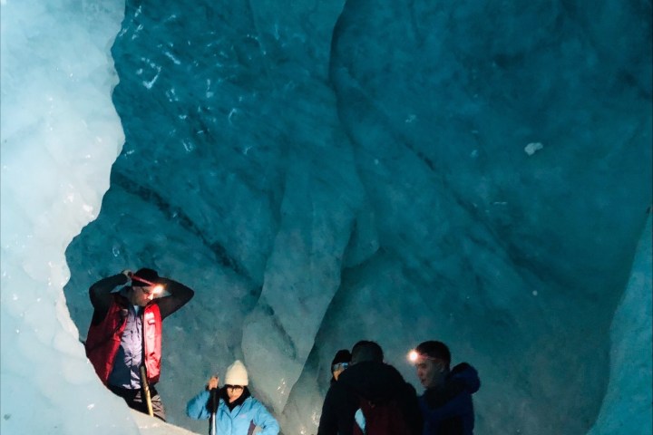 a group of people riding skis on a snowy mountain