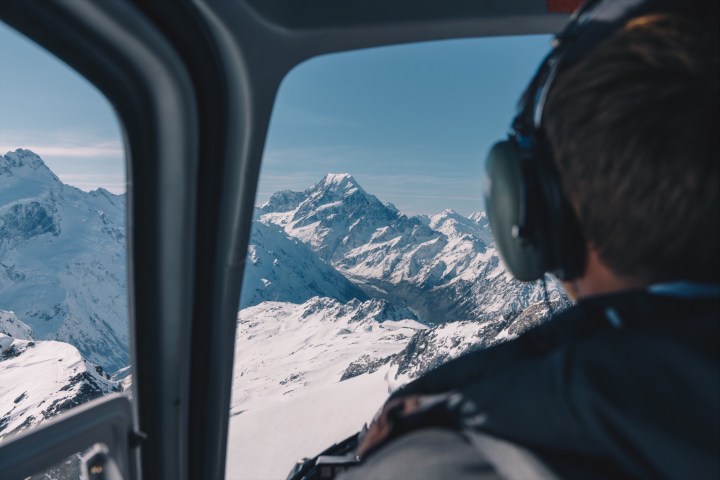 a view of a car with snow on the side of a mountain