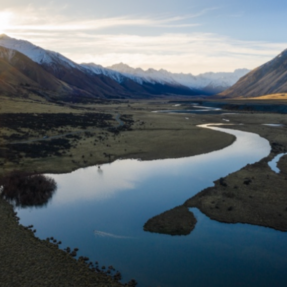 a body of water with a mountain in the background