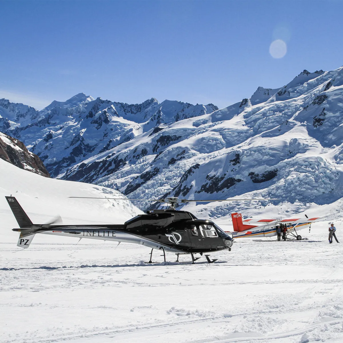 a group of people riding skis on top of a snow covered mountain