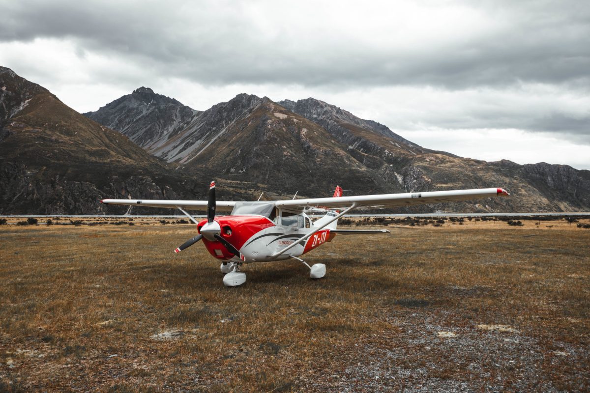0E9A2091 a plane sitting on top of a dry grass field