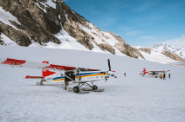 a group of people riding skis on top of a snow covered mountain