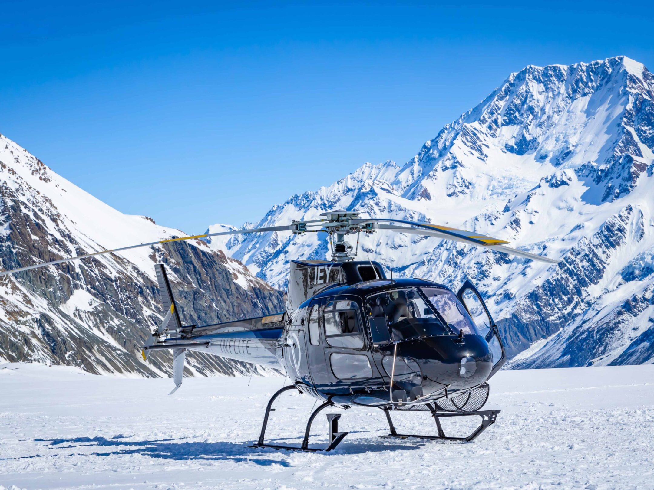 Helicopter landing on Tasman Glacier with Mountain cook in the background