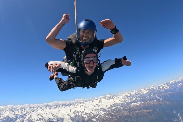 a man flying through the air on a snow board high in the sky