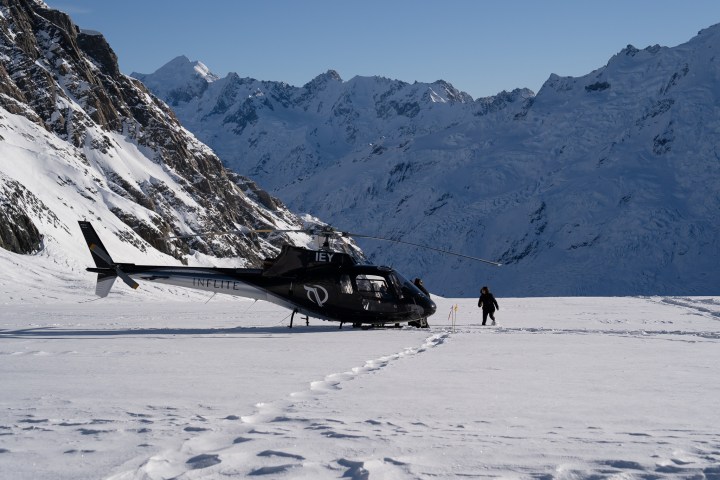 a group of people riding skis on top of a snow covered mountain