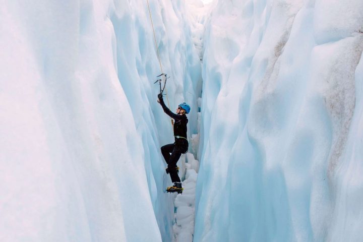 a man riding on top of a snow covered slope