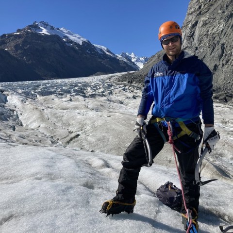 a man standing on top of a snow covered mountain