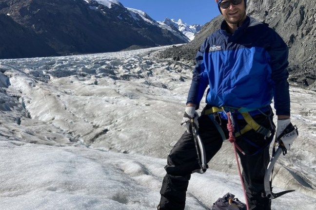 a man standing on top of a snow covered mountain