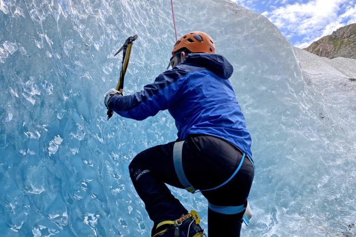 a person riding skis down a snow covered mountain