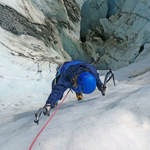 a man riding skis down a snow covered mountain