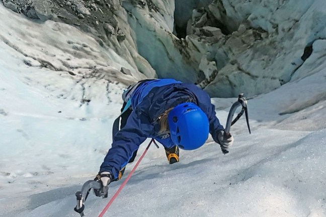 a man riding skis down a snow covered mountain