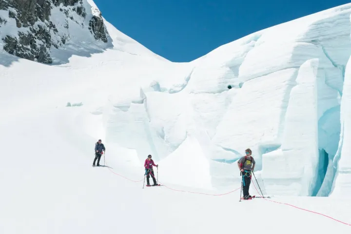 a group of people skiing down a snow covered slope