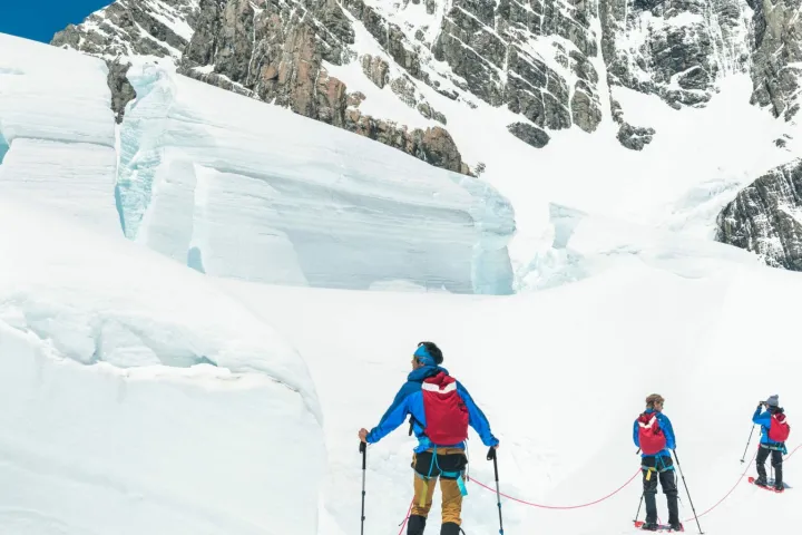 a group of people skiing down a mountain