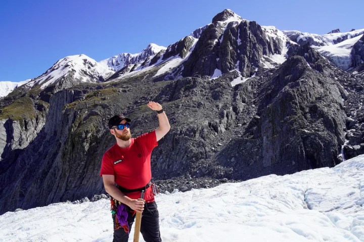 a man standing on top of a snow covered mountain