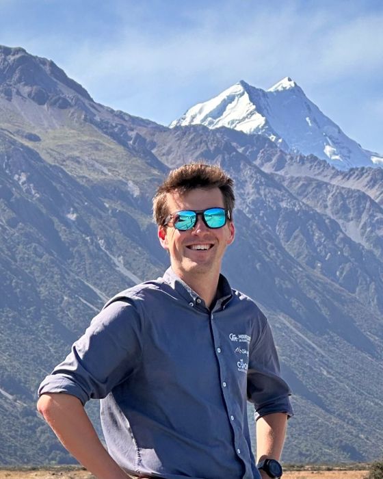 a person standing in front of a mountain
