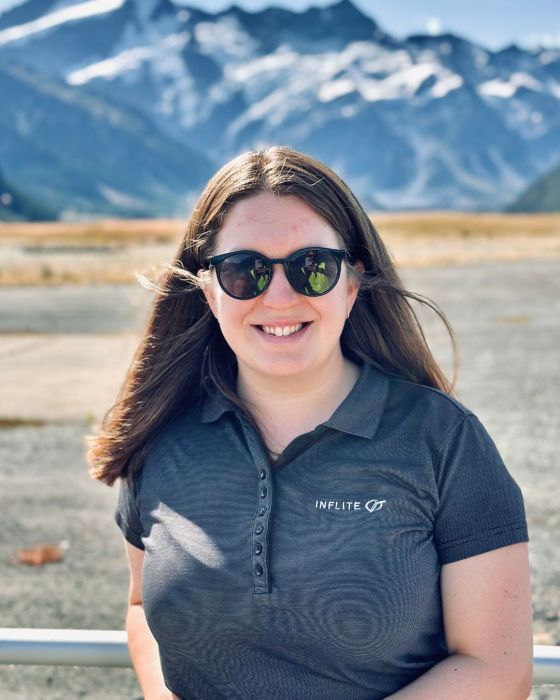 a woman wearing sunglasses posing for the camera