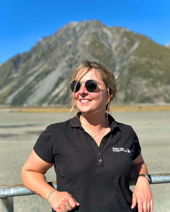 a person standing in front of a mountain