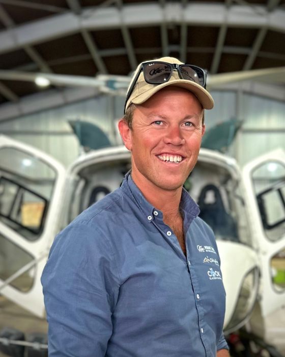 Jeffrey Walker standing in front of a car